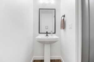 Half Bathroom with hardwood / wood-style flooring on Main Level