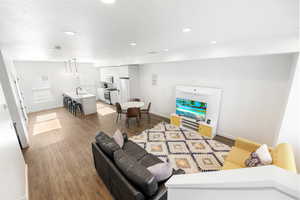 Living room featuring hardwood / wood-style floors and sink