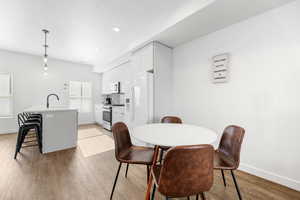 Dining space featuring light hardwood / wood-style floors and sink