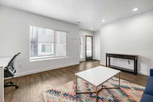 Interior space featuring dark hardwood / wood-style flooring and a healthy amount of sunlight