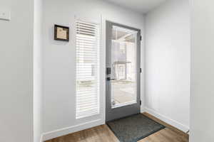 Doorway with hardwood / wood-style flooring