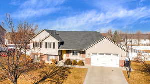 Split level home featuring covered porch and a garage