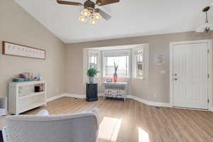 Interior space featuring light hardwood / wood-style floors, ceiling fan, and vaulted ceiling