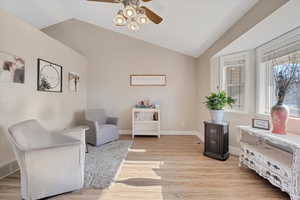 Sitting room with ceiling fan, light hardwood / wood-style flooring, and vaulted ceiling