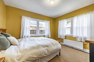 Bedroom with radiator heating unit