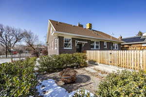 Back of property featuring a fire pit