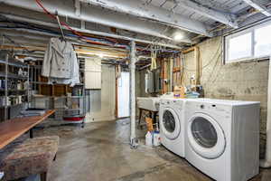 Basement with washer and clothes dryer and sink