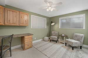 Carpeted office space with ceiling fan