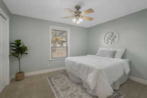 Carpeted bedroom with ceiling fan