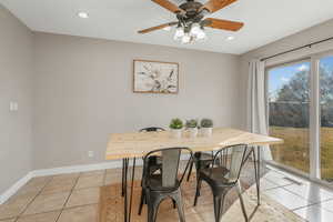 Dining space featuring ceiling fan and light tile patterned floors