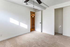 Unfurnished bedroom featuring light carpet, ceiling fan, and a closet