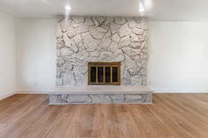 Interior details featuring a fireplace and hardwood / wood-style floors