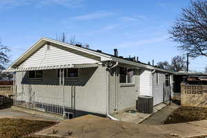 View of side of property with cooling unit