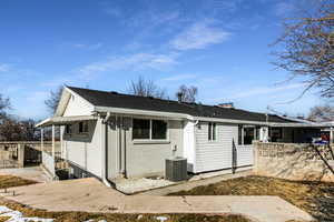 View of front facade with central AC unit and a patio