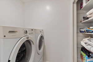 Laundry area featuring washing machine and clothes dryer