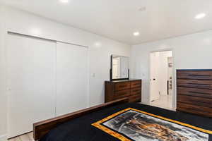 Bedroom with a closet and light hardwood / wood-style floors