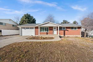 Single story home with a front lawn, a garage, and a porch