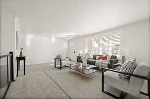 Living room featuring ornamental molding and light colored carpet