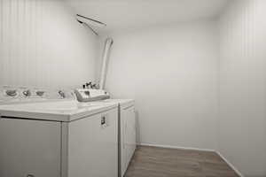 Laundry room featuring hardwood / wood-style flooring and independent washer and dryer