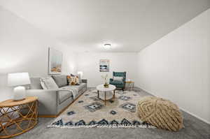 Carpeted living room with a textured ceiling