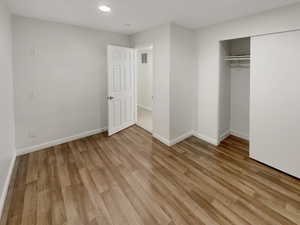 Unfurnished bedroom with a closet and light hardwood / wood-style flooring