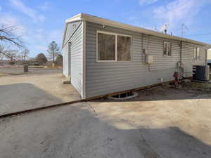 Rear view of house with a patio area and central AC