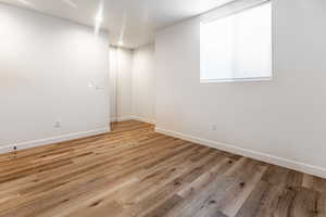 Unfurnished room with light wood-type flooring