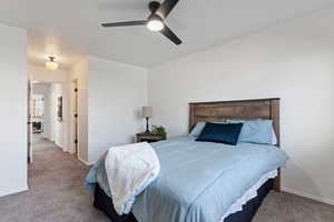 Bedroom featuring ceiling fan and carpet