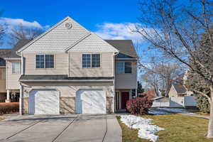 View of front facade with a front lawn and a garage