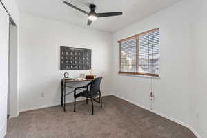 Office space with ceiling fan and carpet flooring