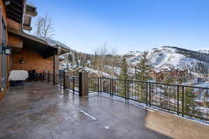 Snow covered patio with a mountain view