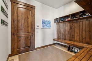 Mudroom with light tile patterned flooring