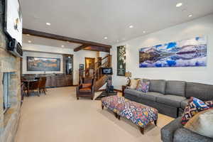 Living room with carpet floors and beam ceiling