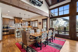 Dining room with a mountain view, dark hardwood / wood-style flooring, and wood ceiling