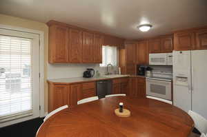 Kitchen with sink and white appliances