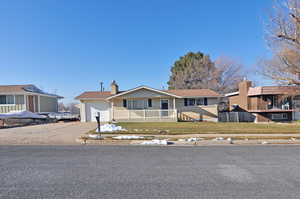 View of front facade featuring covered porch and a garage