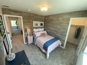 Bedroom with carpet floors, a spacious closet, and a closet