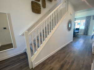 Staircase with a chandelier and hardwood / wood-style flooring