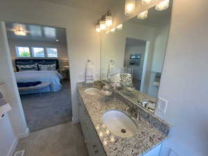 Bathroom with tile patterned floors and vanity