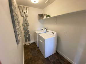 Washroom featuring washing machine and clothes dryer