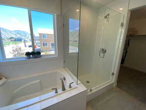 Bathroom featuring a mountain view, tile patterned floors, and plus walk in shower