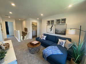 Living room with carpet and washer / dryer