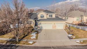 View of property with a garage and a mountain view