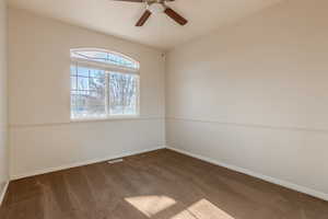 Carpeted spare room with ceiling fan