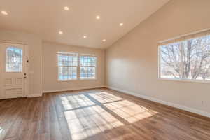 Entrance foyer featuring lofted ceiling and light hardwood / wood-style floors