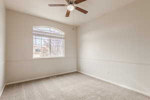 Carpeted spare room with ceiling fan