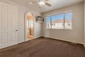 Carpeted spare room with ceiling fan