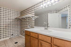 Bathroom with tile patterned floors and vanity