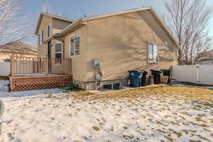 View of snow covered rear of property