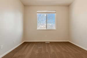 Empty room with dark colored carpet